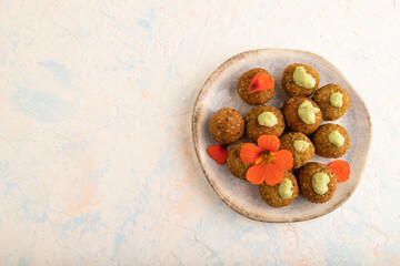 Falafel with guacamole on white concrete. Top view, copy space.