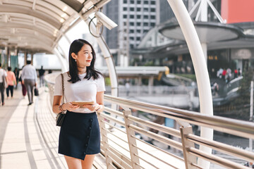 Young adult business working asian woman interactive digital tablet for corporate with team via online.