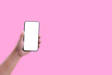Fototapeta na wymiar Hand holding smartphone with blank screen isolated on pastel pink color background with clipping path. ideas design business concept.