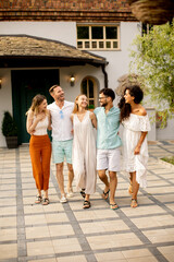 Group of happy young people walking and cheering together