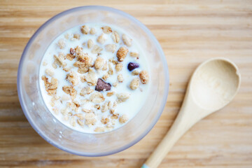 breakfast cereal and milk in a glass on table 