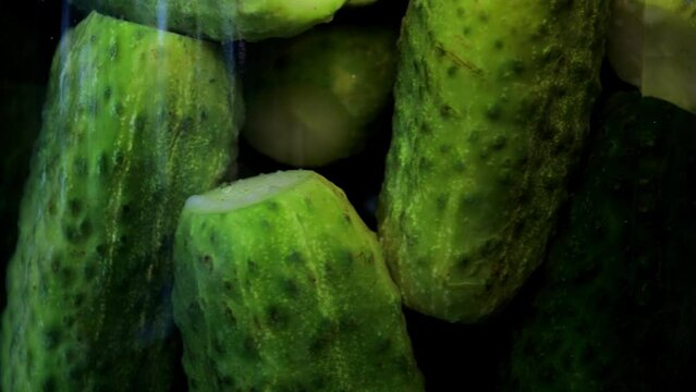 Pickles close up. Pickled green cucumbers in a glass jar.
