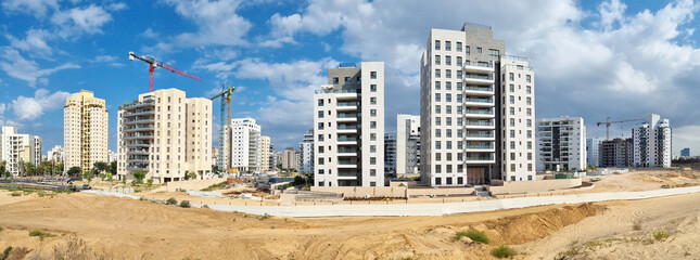 City construction among desert dunes. Building yard of Housing construction of houses in  new area...