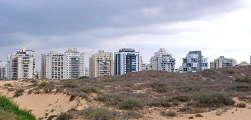 City construction among desert dunes. Building yard of Housing construction of houses in  new area of the city Holon in Israel