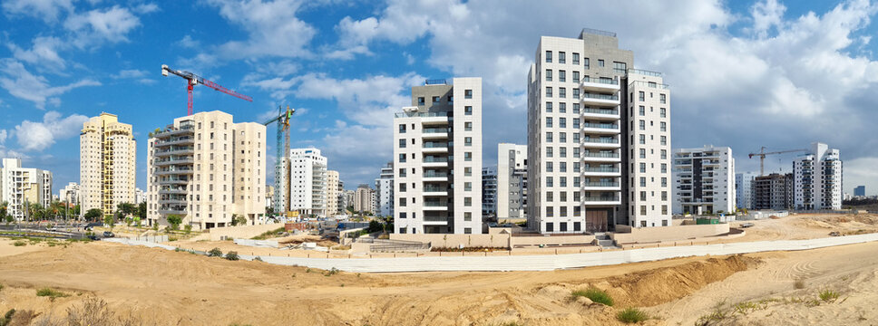 City construction among desert dunes. Building yard of Housing construction of houses in  new area of the city Holon in Israel