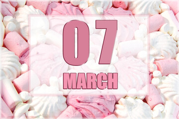 calendar date on the background of white and pink marshmallows.  March 7 is the seventh day of the month