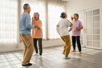 Group of old people with smiling faces convey satisfaction at the beautiful time and dancing at home with happy expression, Retirement Lifestyle of Asian senior