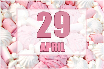 calendar date on the background of white and pink marshmallows. April 29 is the twenty-ninth day of the month