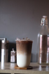Closeup of Iced Caramel Macchiato at the coffee shop, Caramel Macchiato is a classic macchiato beverage. It consists of vanilla syrup, espresso, steamed milk, foam, and caramel drizzle