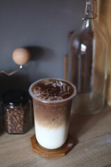 Closeup of Iced Caramel Macchiato at the coffee shop, Caramel Macchiato is a classic macchiato beverage. It consists of vanilla syrup, espresso, steamed milk, foam, and caramel drizzle