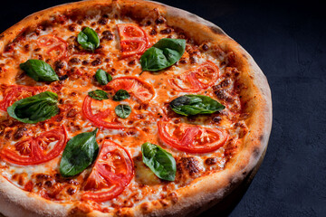 Delicious fragrant pizza with mozzarella, tomatoes and basil with tomato sauce - Margherita