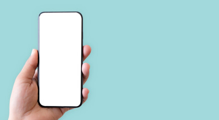 Hand holding smartphone with blank screen isolated on pastel green color background with clipping path. ideas design business concept.