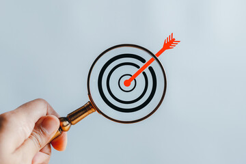 Magnifier glass focus to target  icon which for planning development leadership and customer target...