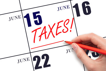 Hand drawing red line and writing the text Taxes on calendar date June 15. Remind date of tax...