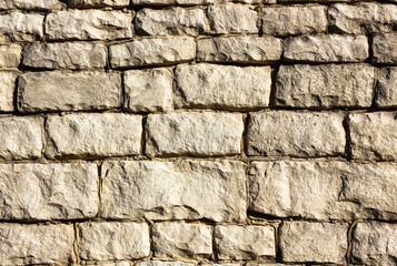 Stone wall background, texture of rough stonework close-up
