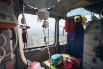 Selective focus on infusion on board helicoter of emergency medical service. Themes rescue, urgency and health care..