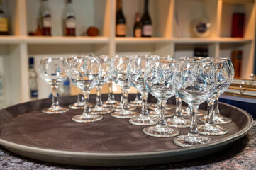 Stack of white plates and empty wine glasses