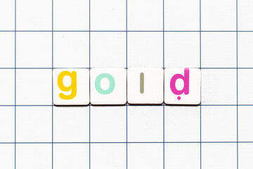 Colorful tile letter in word gold on white grid background