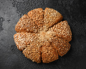 Fresh Homemade seeded share bread on rustic dark background