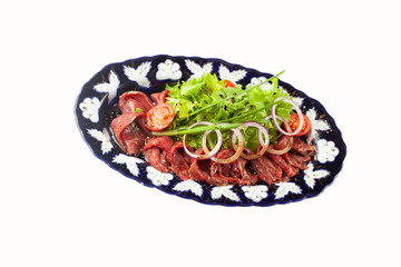 Dried meat and salad in a plate.