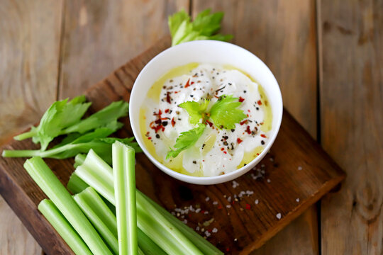 Celery Sticks With White Sauce In A Bowl. Healthy Food.