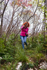 Hiker lady with camera on a steep trail