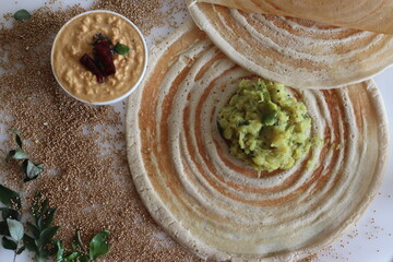 Kodo millet masala dosa. Thin crispy crepes made of kodo millet and lentils flour, stuffed with spiced mashed potatoes