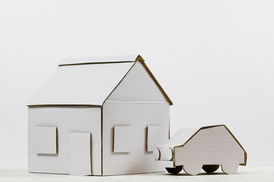 A paper model of a house with a car model