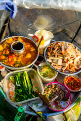 Snack at break time. Famous Vietnamese food is Banh mi thit, popular street food from bread stuffed with raw material: pork, ham, pate, egg and fresh herbs