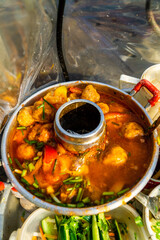 Snack at break time. Famous Vietnamese food is Banh mi thit, popular street food from bread stuffed with raw material: pork, ham, pate, egg and fresh herbs