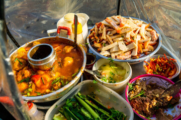 Snack at break time. Famous Vietnamese food is Banh mi thit, popular street food from bread stuffed with raw material: pork, ham, pate, egg and fresh herbs