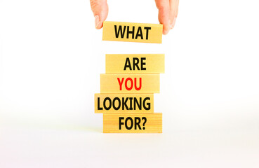 What are you looking for symbol. Concept words What are you looking for on wooden blocks. Businessman hand. Beautiful white background. Business what are you looking for concept. Copy space.