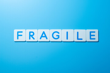 Word FRAGILE on blue background,FRAGILE Concept