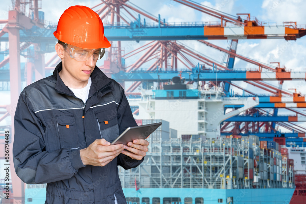 Poster Port manager with a digital tablet against the background of a ship loaded with containers in the seaport