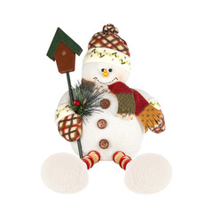 Funny plush snowman sitting and holding a spruce branch and a birdhouse in his hands on a white...