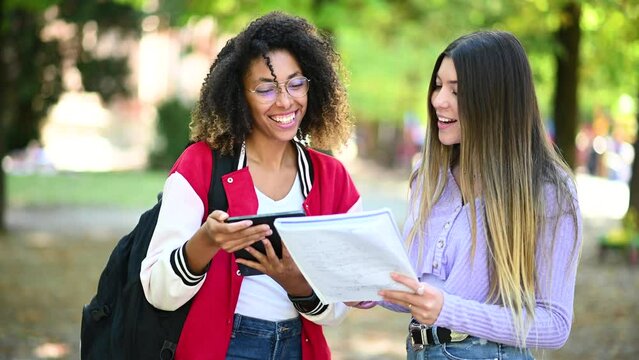 Female multiethnic students having a conversation outdoor