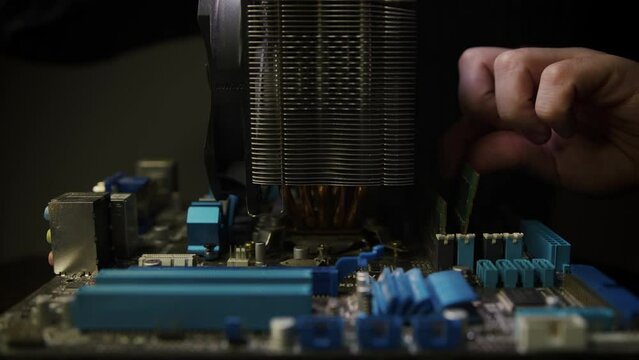 Close-up Moving Macro Shot: Inside of the Computer Case. Camera Moves Over PCB Motherboard, Showing Multiple Slots with RAM Memory Installed, and Other System Hardware