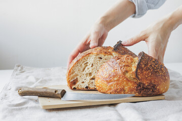 woman cooks homemade yeast-free sourdough bread. Healthy food. a woman baker in a light apron is...