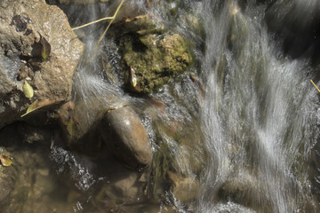 The water of a river flows between the rocks.