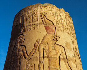 Colored ancient egyptian carvings on the columns of Kom Ombo temple in Aswan 