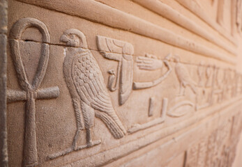 Ancient egyptian symbols and hieroglyphics carved at Kom Ombo temple, Egypt - obrazy, fototapety, plakaty