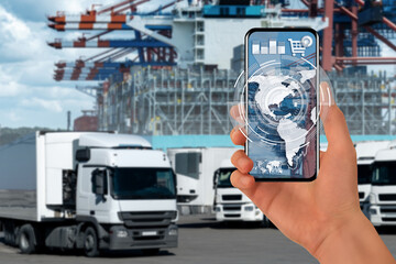 Fototapeta na wymiar Hands with smartphone on a background of a ship loaded with containers in the seaport. International trade and logistics concept