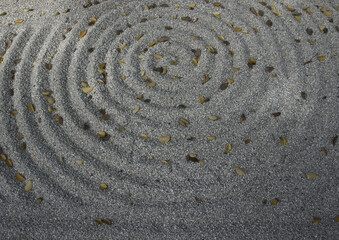Fototapeta na wymiar In a Zen garden, a circle is drawn in the sand, like a vortex.
