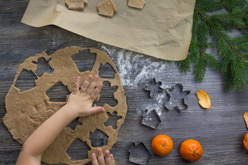 New Year and Christmas decorations on a wooden surface with flour, tangerines and a Christmas tree....