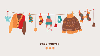 Cozy winter banner with knitted warm sweaters on rope. Seasonal clothes and accessories, socks and mittens, christmas toys. Cute warmy vector elements on string