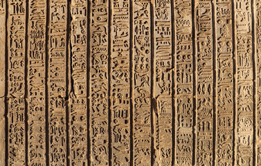 Ancient egyptian hieroglyphics carved on wall at Kom Ombo temple, Aswan, Egypt 