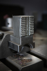 Metal vise in the production of bearings.Vertical photo.Metal shavings.