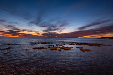Sunsets in Cilento, Italy. Fiery horizons at sunset. wave motion.