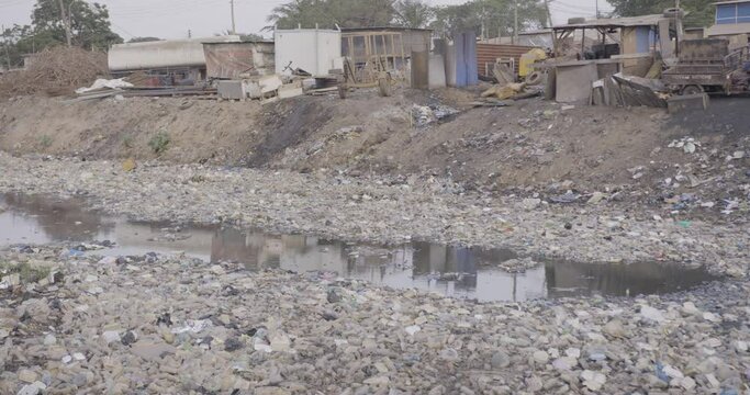 Filthy river filled with plastic and e-waste.