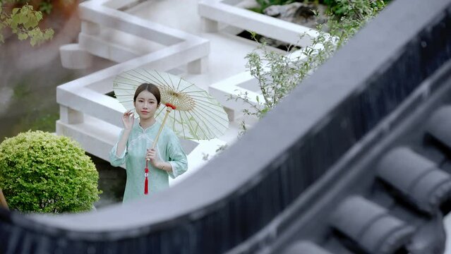 young beautiful Chinese female in qipao in china-style yard villa